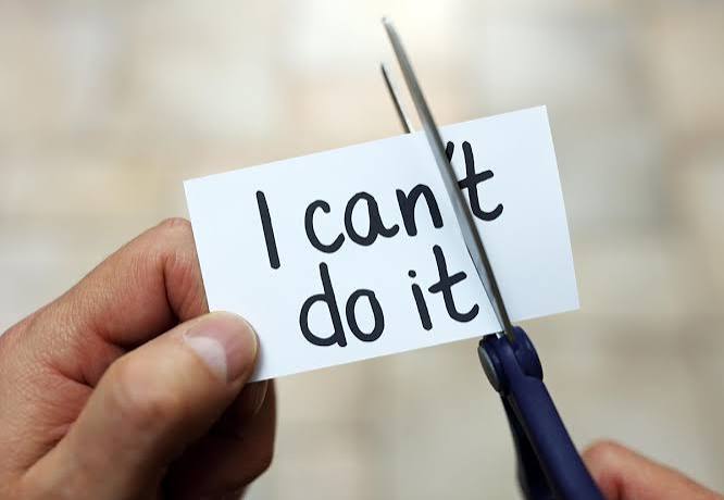 Person cutting out the word can't to can in I can't do it phrase